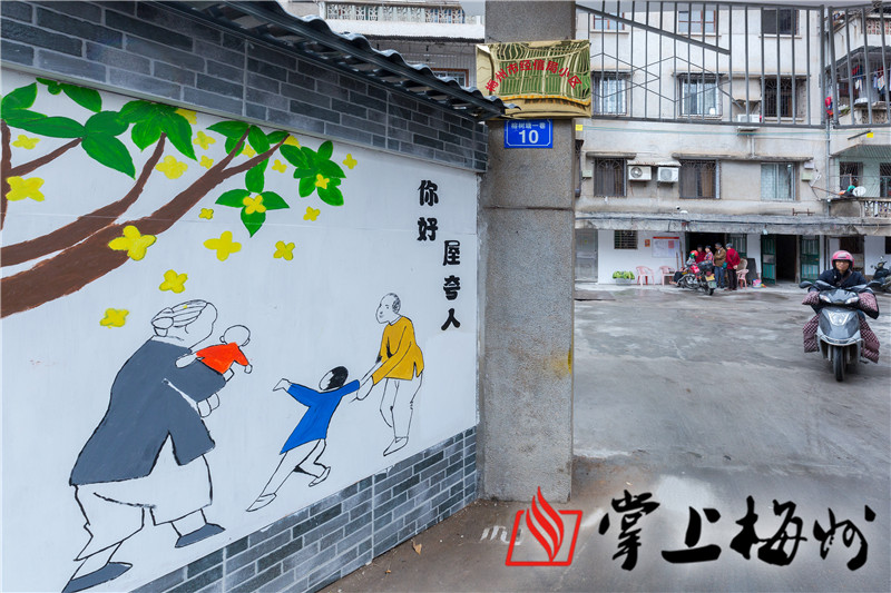 江南社区市经信局小区大门前的墙画上了有客家特色的"你好,屋夸人"